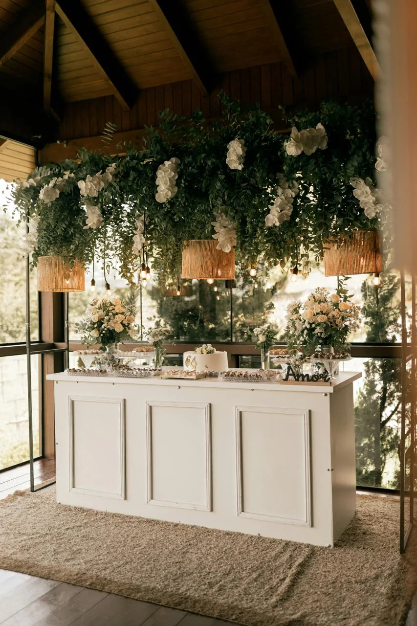 Greenery and white bloom installation above a venue bar