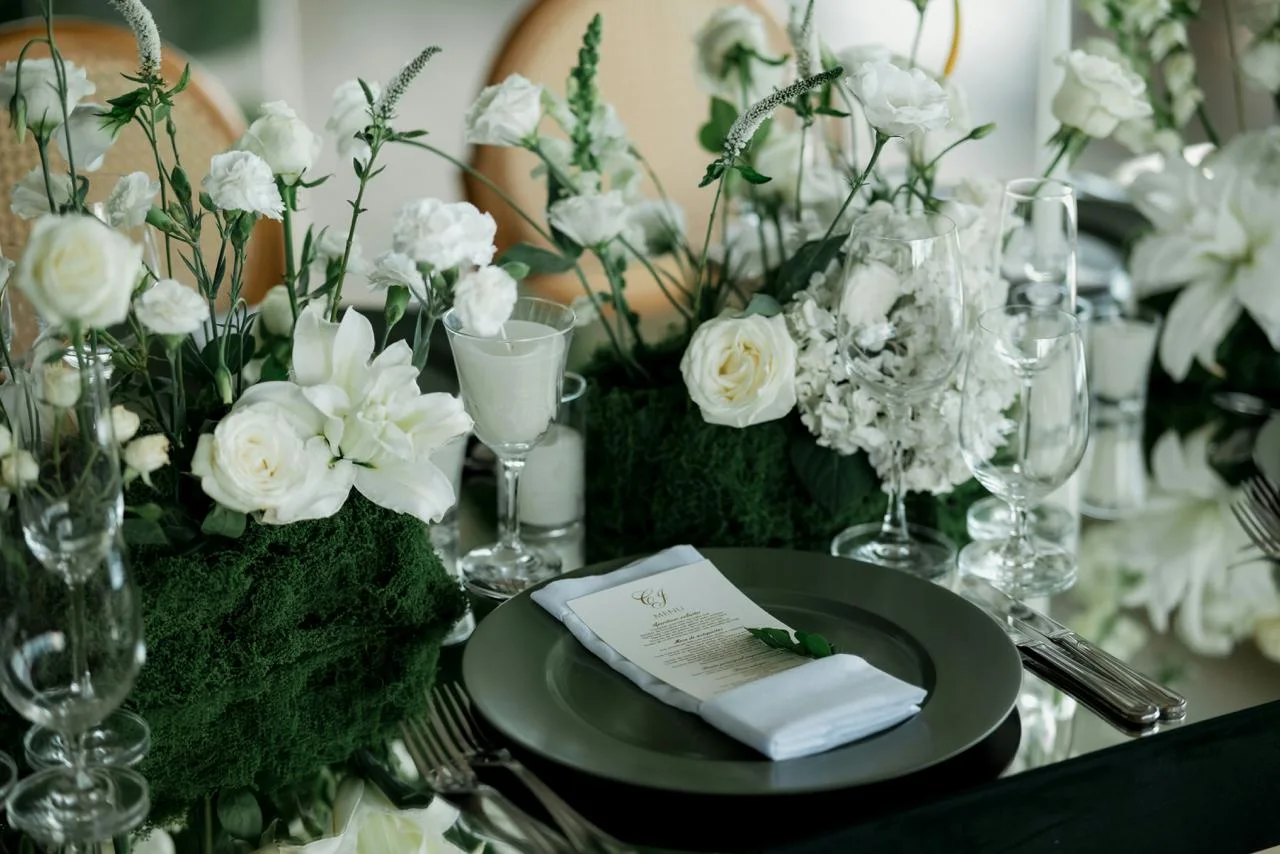 White and green centerpieces on a modern dining table