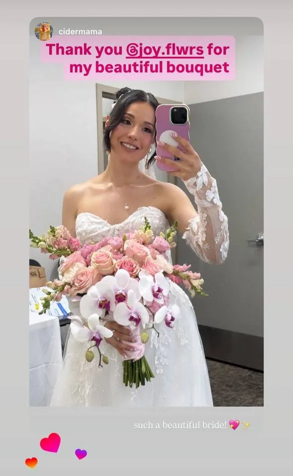 Bride thanking Joy Flowers Studio for her wedding bouquet with orchids